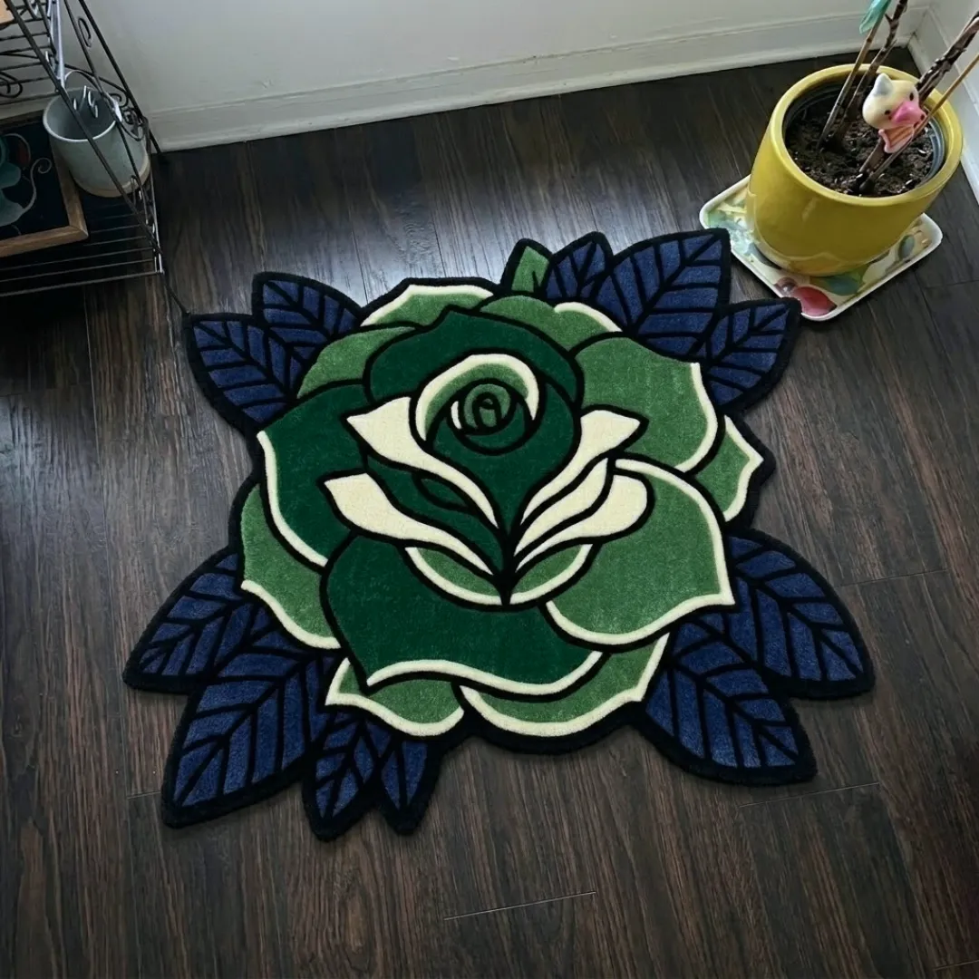 sage thorne rug top view Sage Thorne traditional tattoo style green rose shaped tufted area rug displayed flat on a dark wooden floor.