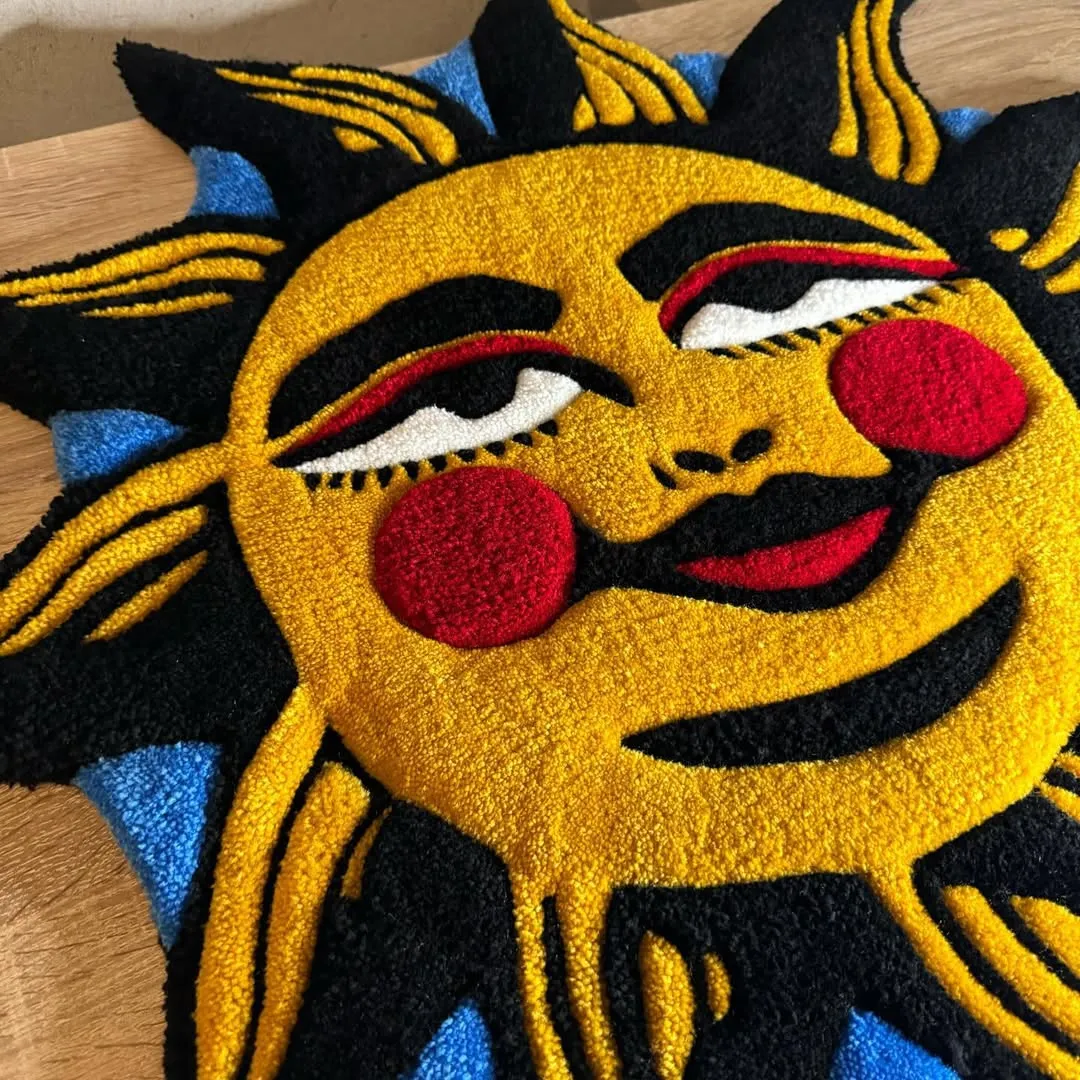 Hand-tufted wool rug showcasing bold tattoo-inspired sun illustration – Solar Smile Rug by Sneagear