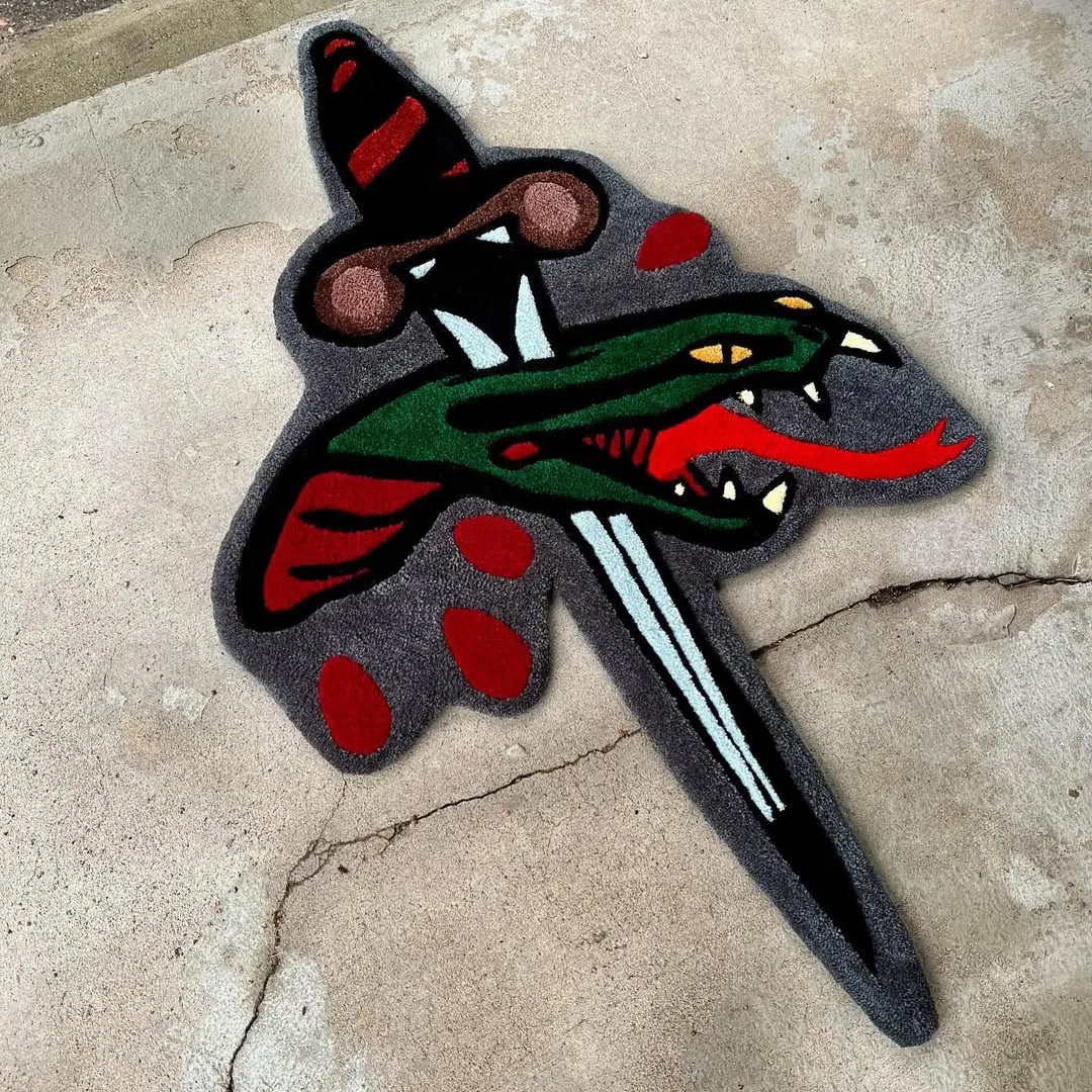 Hand-tufted wool rug showcasing snake and dagger tattoo motif – Viper Pierce Rug by Sneagear