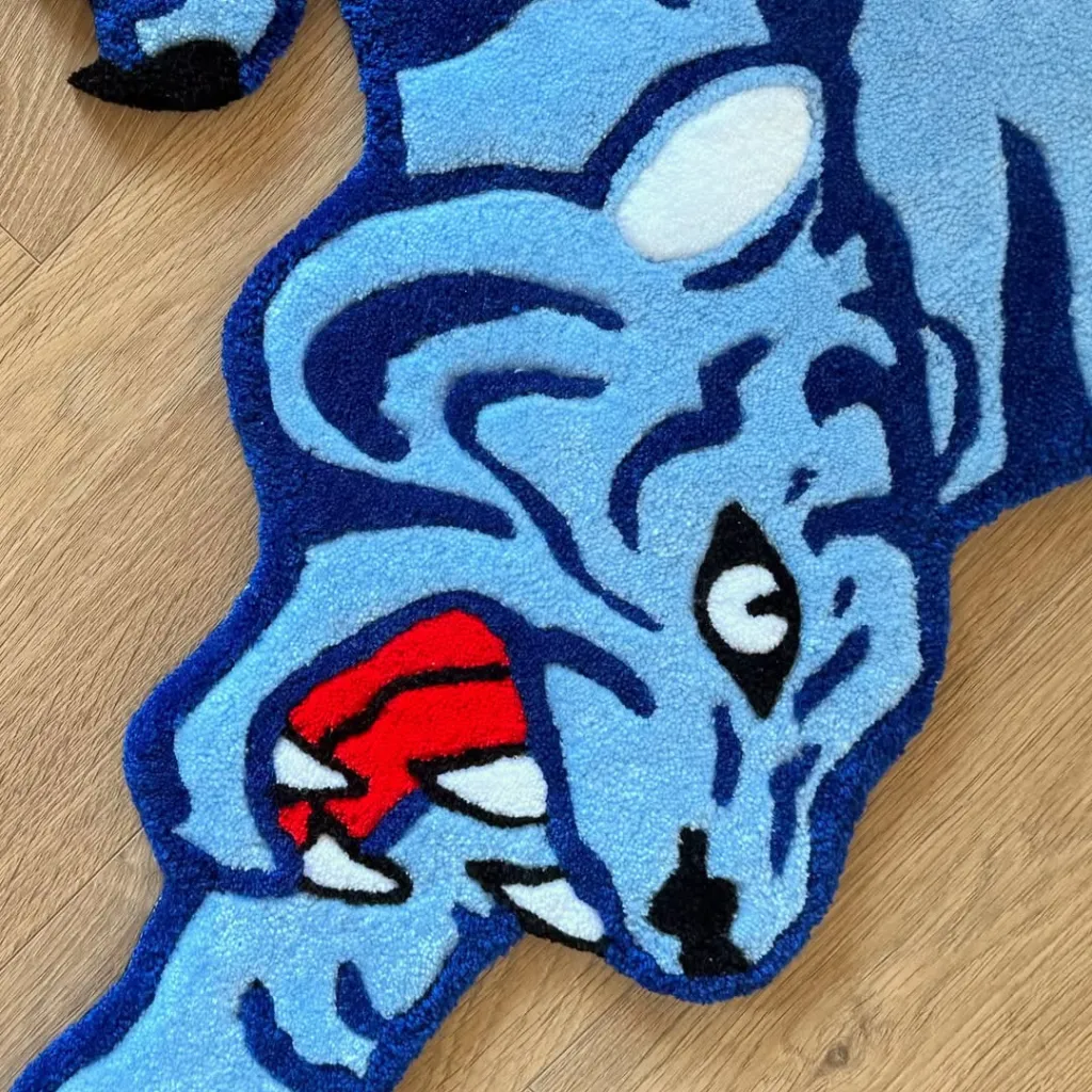 Close up texture shot of the Cool Fang rug highlighting the tufted wool details of the blue tiger face and open red mouth.
