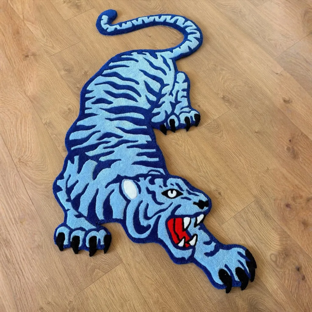 Top down view of the Cool Fang Inked rug showing the full shape of the crawling blue tiger with black stripes.