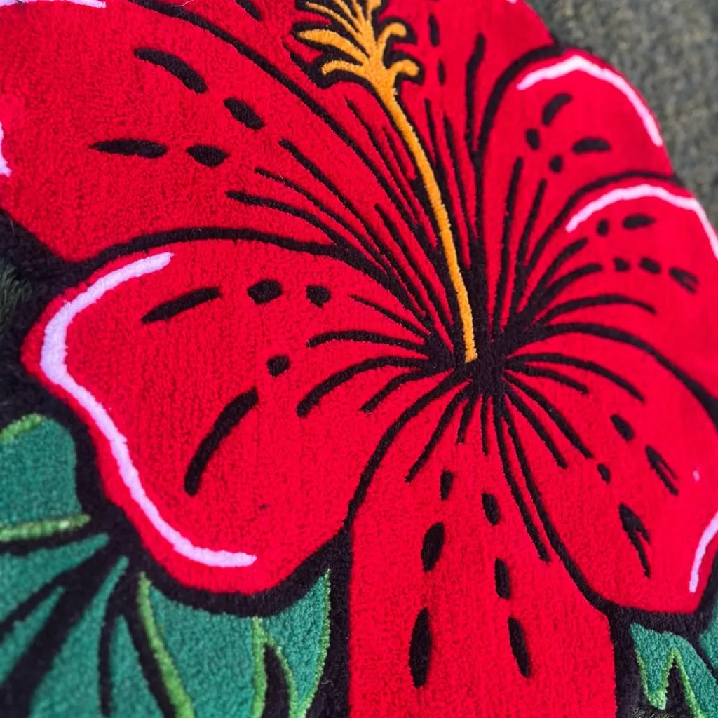 Angled close up shot of the Ember Petal rug highlighting the plush cut pile and vivid red color of the floral design.