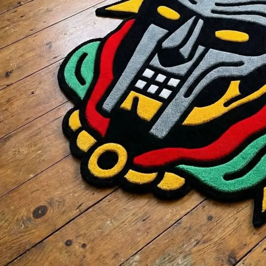 Close up angled shot of the Graffiti Deity rug showing the dense black and grey wool tufting and hand carved details.