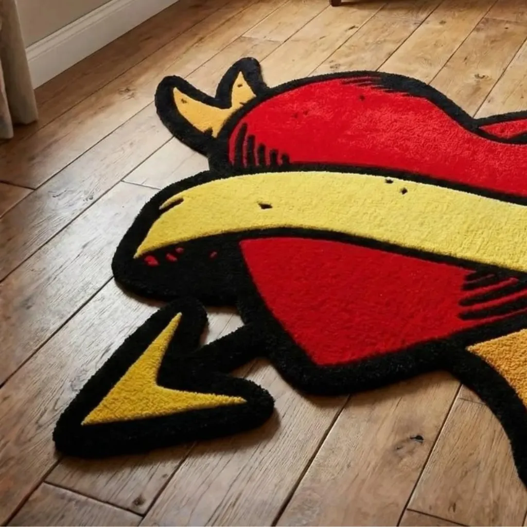 Close up angled perspective of the Wounded Heart rug showing the vibrant red wool and black outline of the tattoo inspired design.