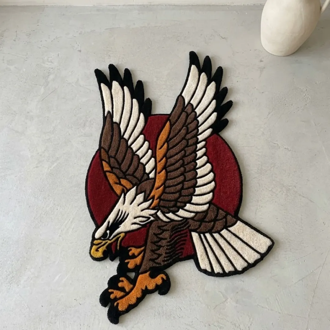 Full view of a tufted American eagle traditional rug featuring a diving brown and white eagle against a red circle background on a light floor next to a white vase.