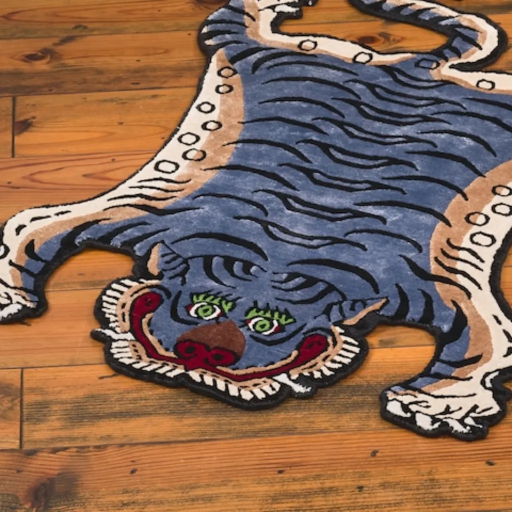 Angled view of the Ashen Claw rug, highlighting the dense hand-tufted wool texture and the intricate black stripe pattern on a unique blue-grey background.