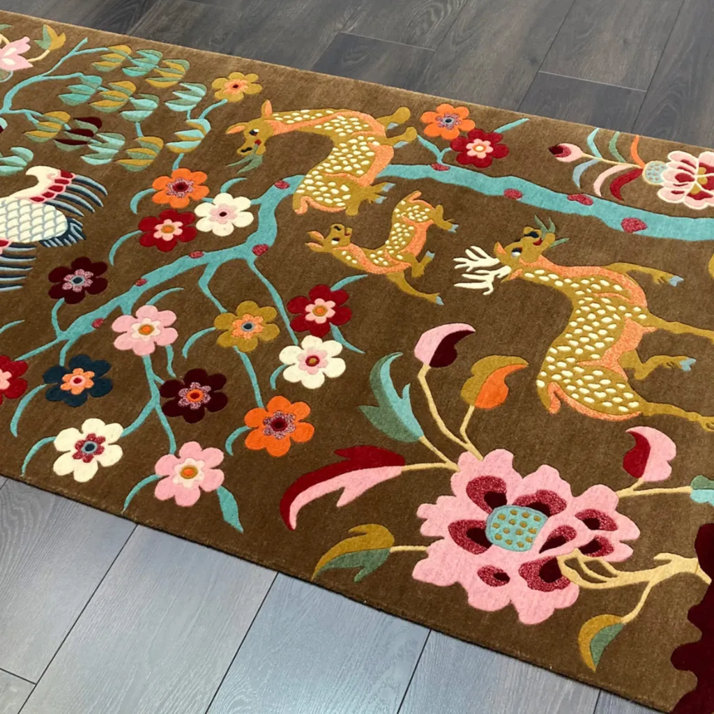 Close up detail shot of the Earthen Story rug highlighting the intricate hand tufted wool texture and the vibrant spotted deer and floral motifs.