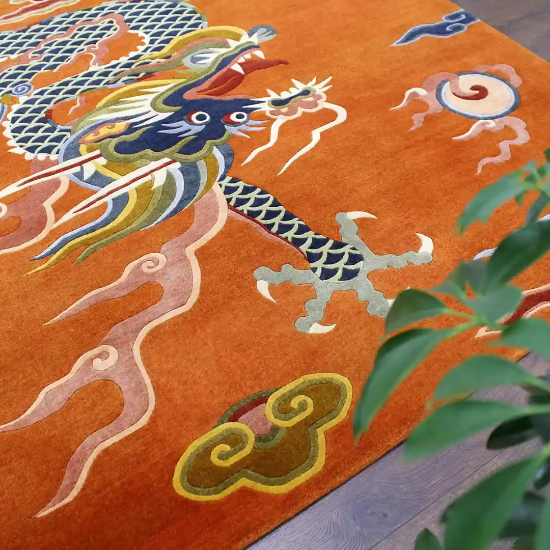 Close up detail shot of the Ember Rise rug focusing on the hand tufted texture of the dragon's head and scales, showcasing the premium craftsmanship and intricate colors.