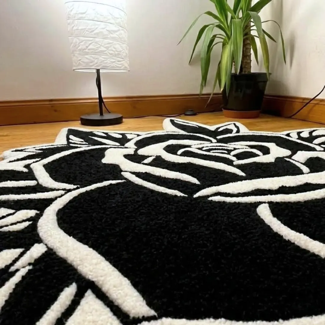 gothic black rose shaped area rug texture close up A detailed close-up perspective of the gothic black rose rug, highlighting the dense, high-quality tufted wool texture and the sharp, graphic black-and-white contrast.