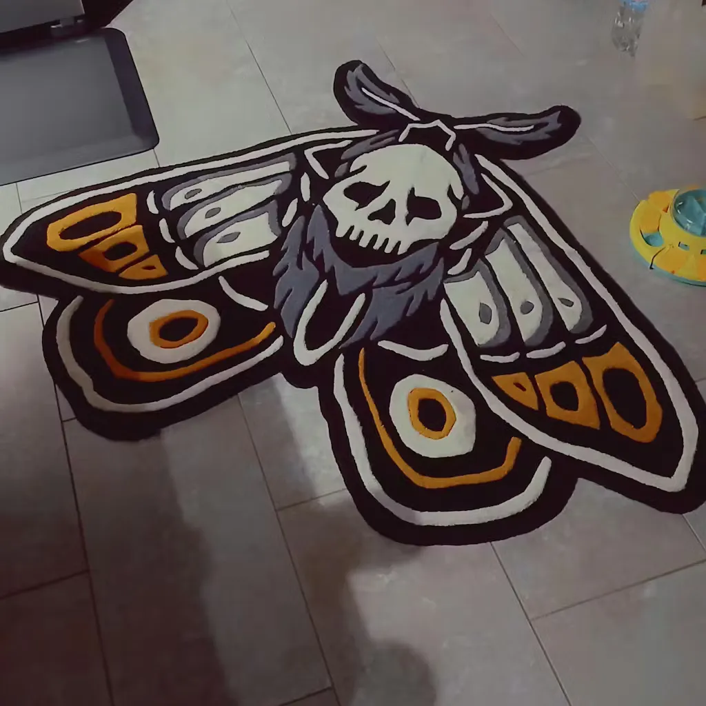 gothic home decor moth area rug High angle shot of the skull moth rug styled in a bedroom corner, highlighting the bold black outlines and gothic aesthetic near a reading chair.