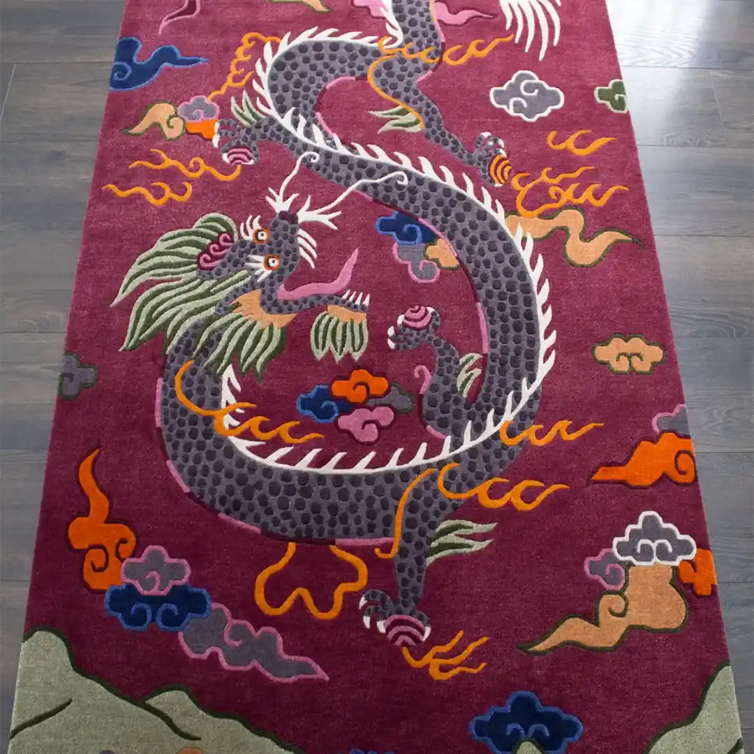 Angled perspective of the Crimson Omen rug highlighting the intricate hand tufted details of the dragon head and the vibrant orange and blue cloud motifs.
