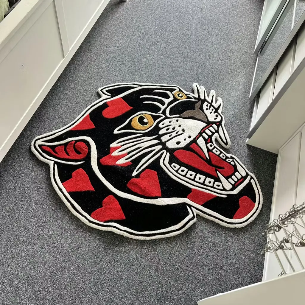 Angled view of the panther head rug placed on a floor, showcasing its unique die-cut shape and dense wool pile texture against white furniture.
