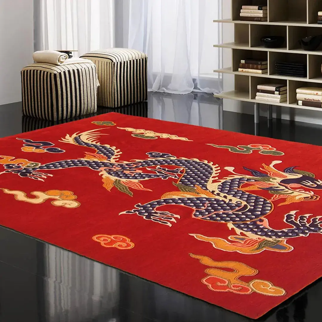 Angled view of the Imperial Flame rug placed on a dark polished floor in a modern living space, featuring a vibrant red wool background with a large, intricate blue Tibetan dragon and cloud motifs.