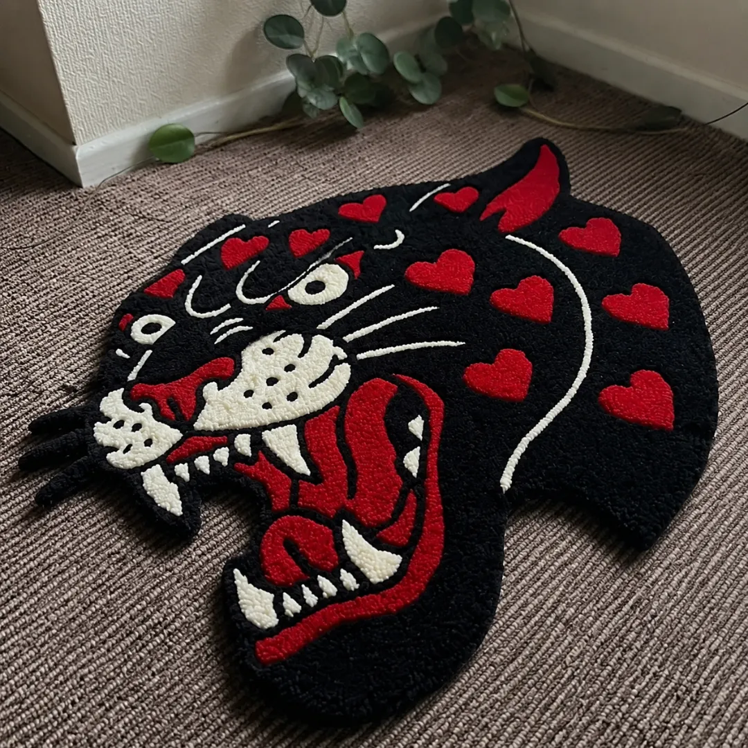 red panther head american rug angle view Angle view of the handmade Red Panther Head tufted rug showcasing its unique organic contours and bold tattoo-inspired design.