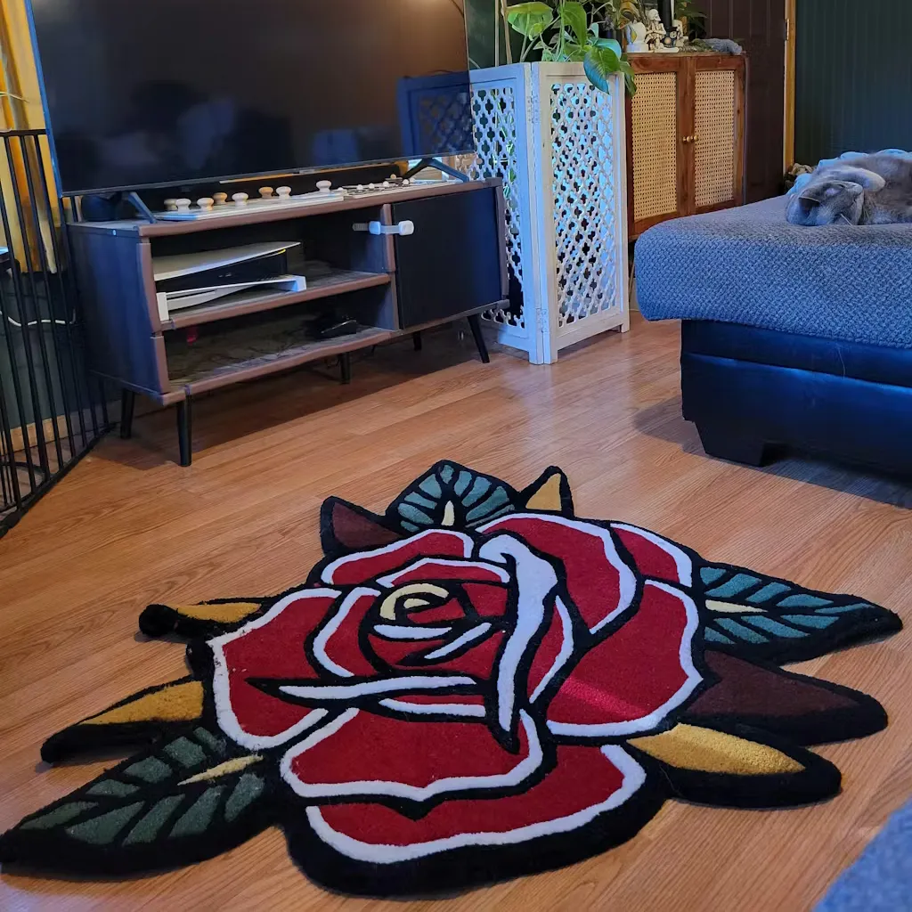 Traditional Tattoo Style Rose Floor Rug High angle shot of the Red Rose rug placed on a wooden floor in a tattoo studio, complementing the vintage body art aesthetic with its classic floral motif.