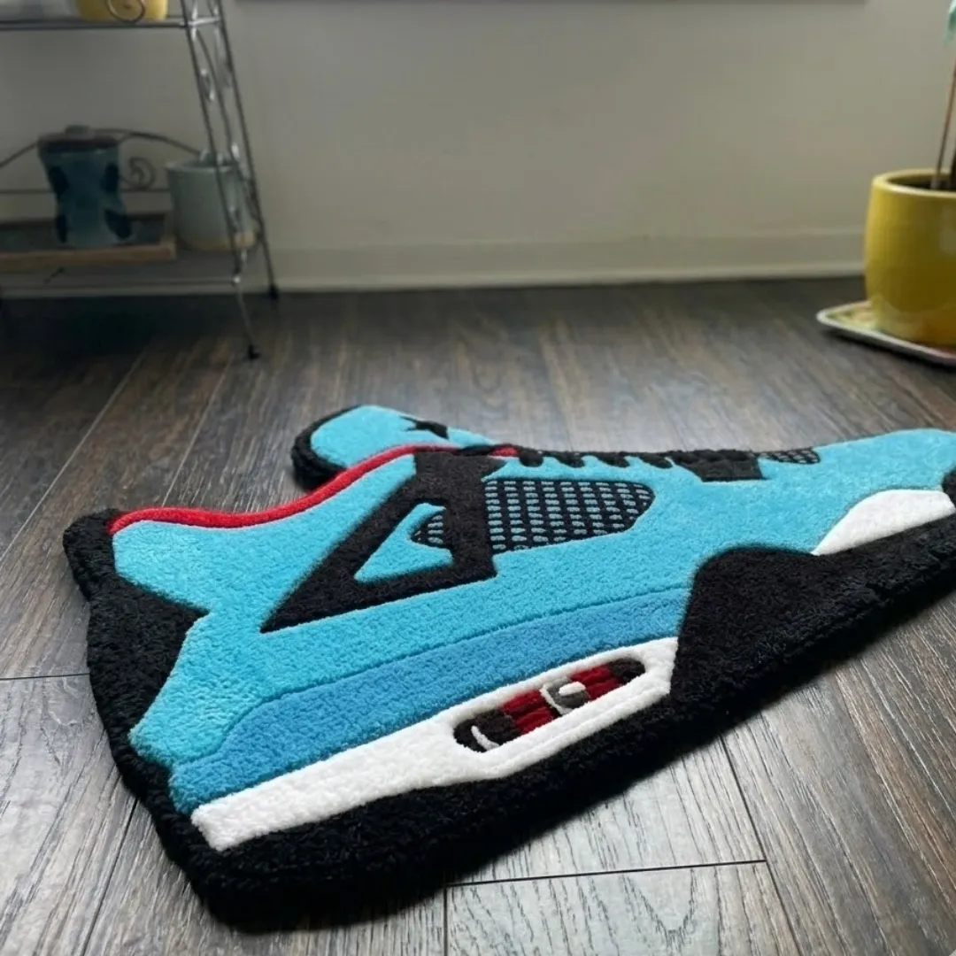 Angle view of the handmade Aqua Velocourt tufted rug showcasing its unique contours and texture.