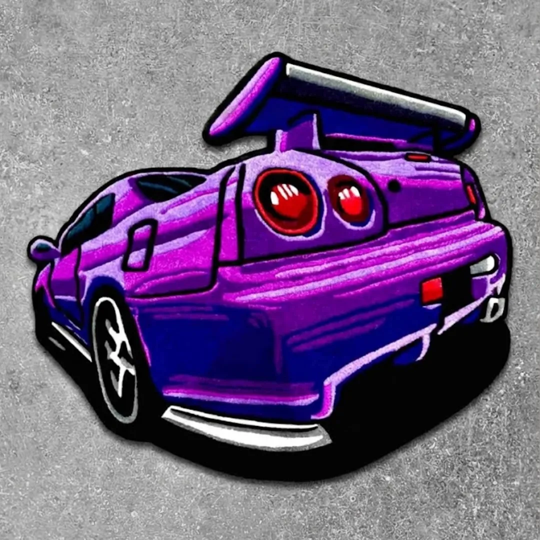 Top down view of the Arrow Crest rug featuring a custom die-cut design of a purple JDM sports car rear with a large spoiler and iconic round red taillights.