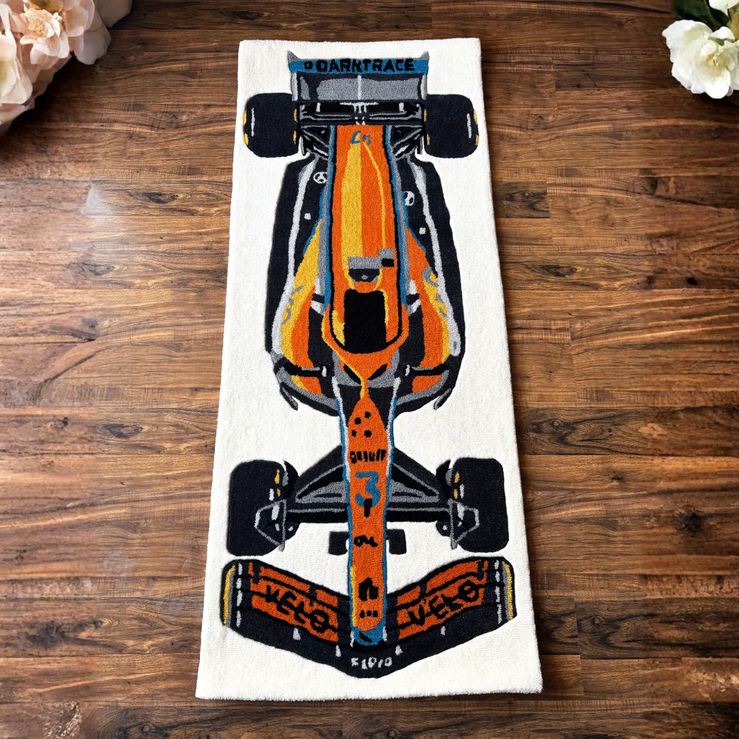 Full top-down view of the Ignite Rush runner rug showcasing the complete Formula 1 race car design in bold orange and blue tones.