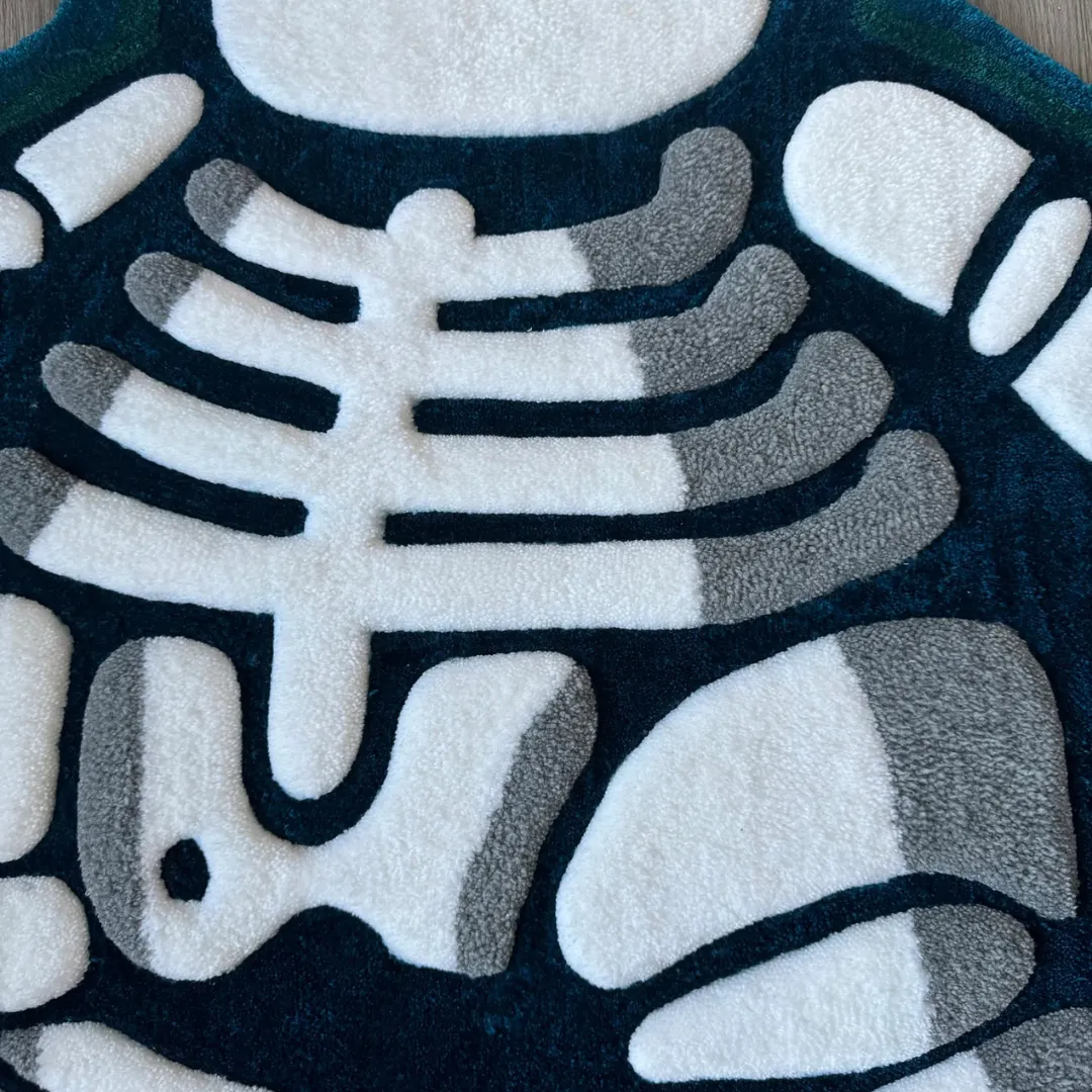 Close-up macro shot of the Lazy Lax rug showing the high-quality tufted wool texture and precise carving of the white skeletal design.
