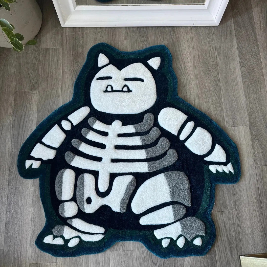Top down view of the Lazy Lax rug featuring a custom die-cut shape of a sleeping monster skeleton in deep teal and white hand-tufted wool.