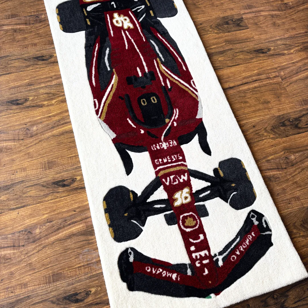 Close-up detail of the Scarlet Force rug's nose, showcasing the number 16, sponsor logos, and the precise tufting of the front wing assembly.