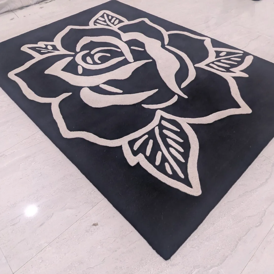Full view of the Shadow Rose rug featuring a bold, oversized white rose outline design on a deep black hand-tufted wool background.