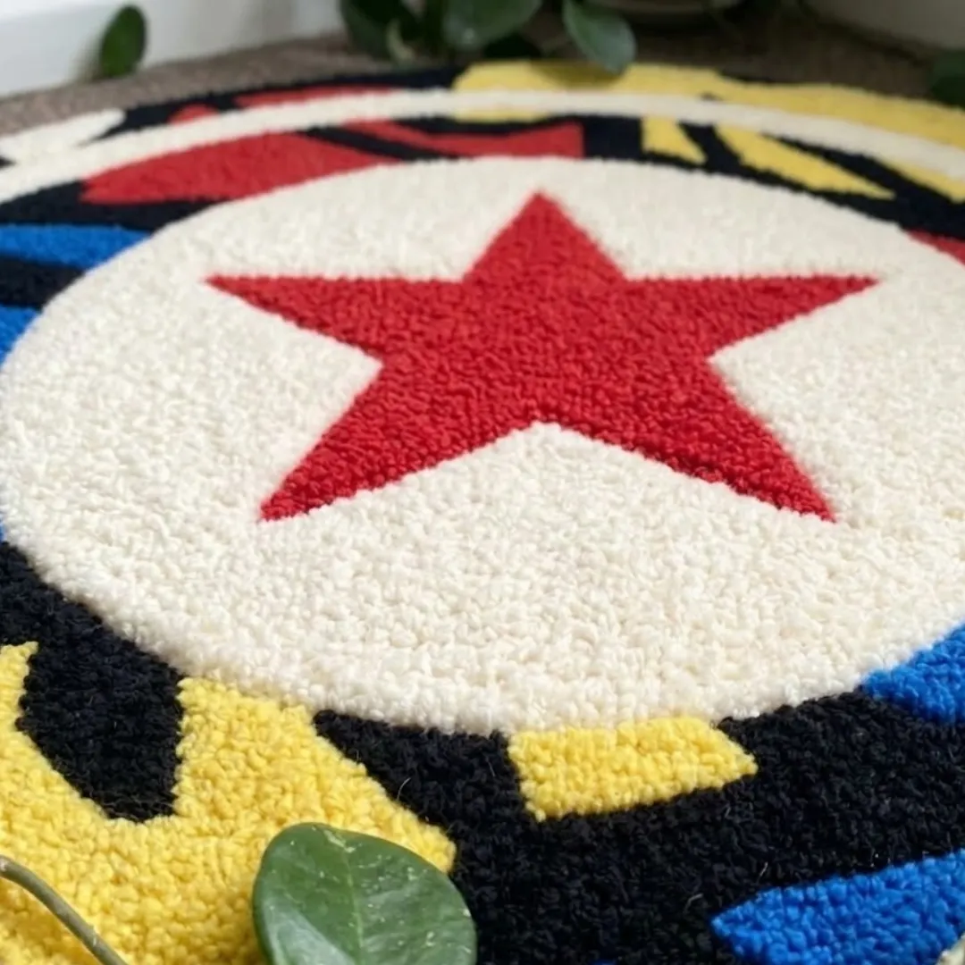 Angle view of the handmade Spectrum Kickmark circular tufted rug showcasing its vibrant colors and texture.