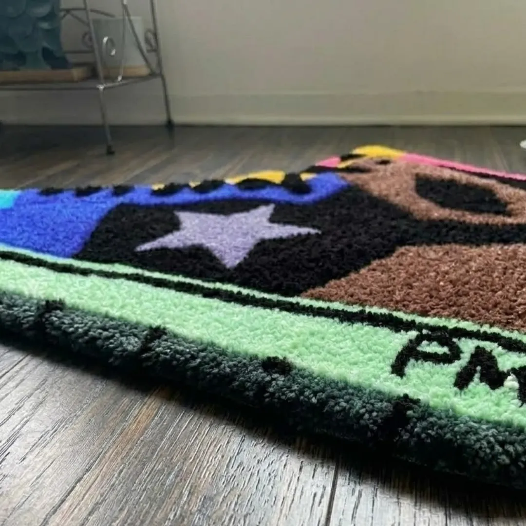 Close-up of the detailed tufted pile texture, star logo, and colorful design on the Terra Lace Foam rug.