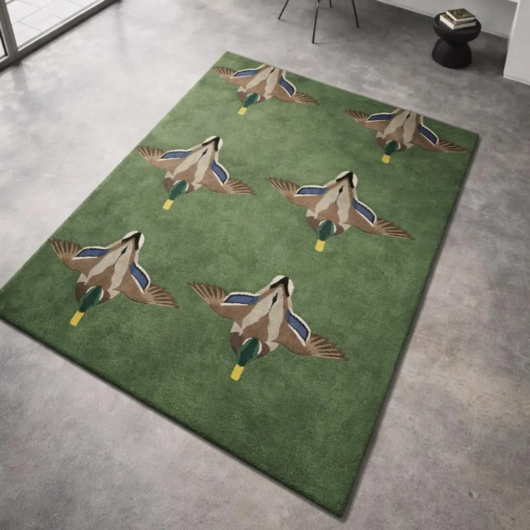 The Verdant Flight rug styled in a modern home office, showing how the wildlife motif adds character and a nature-inspired touch to a minimalist workspace.