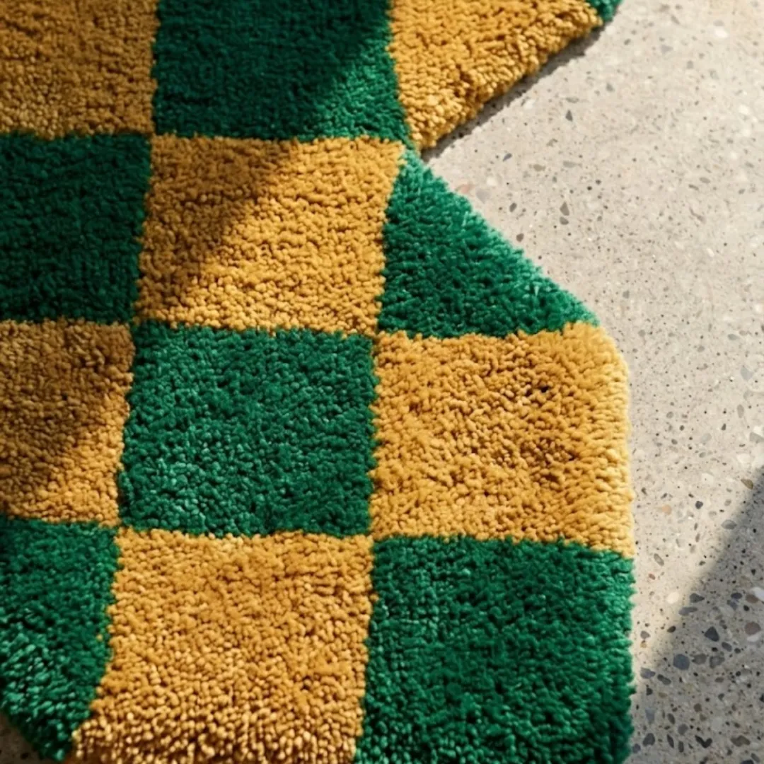 chess leaf grove detail Close-up view of the Chess Leaf Grove rug, highlighting the dense, plush hand-tufted wool texture and the clean lines of the green and golden yellow checkerboard pattern.