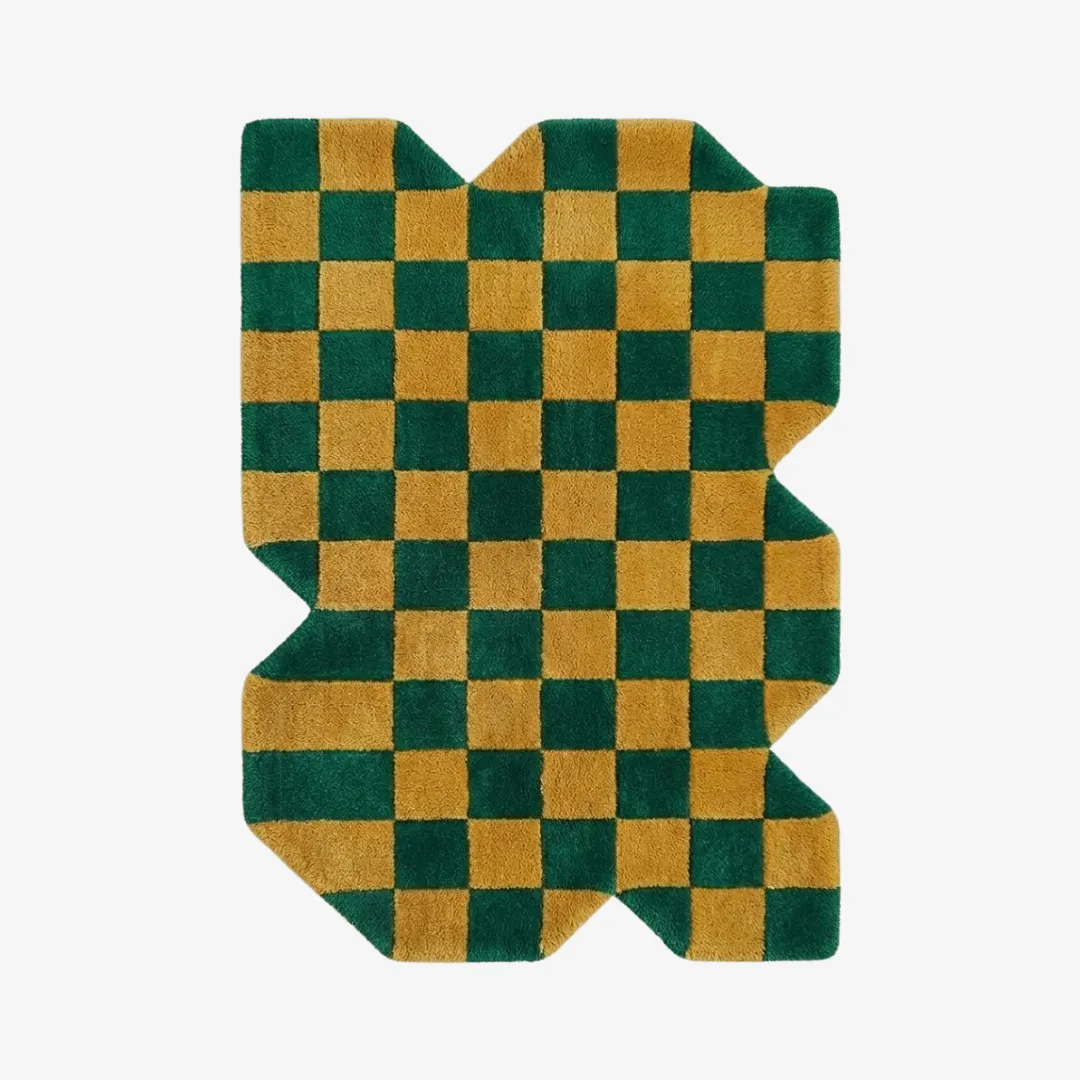 chess leaf grove rug A top-down view of the Chess Leaf Grove rug against a white background, featuring a bold checkerboard pattern in forest green and golden yellow with a unique, jagged irregular silhouette.