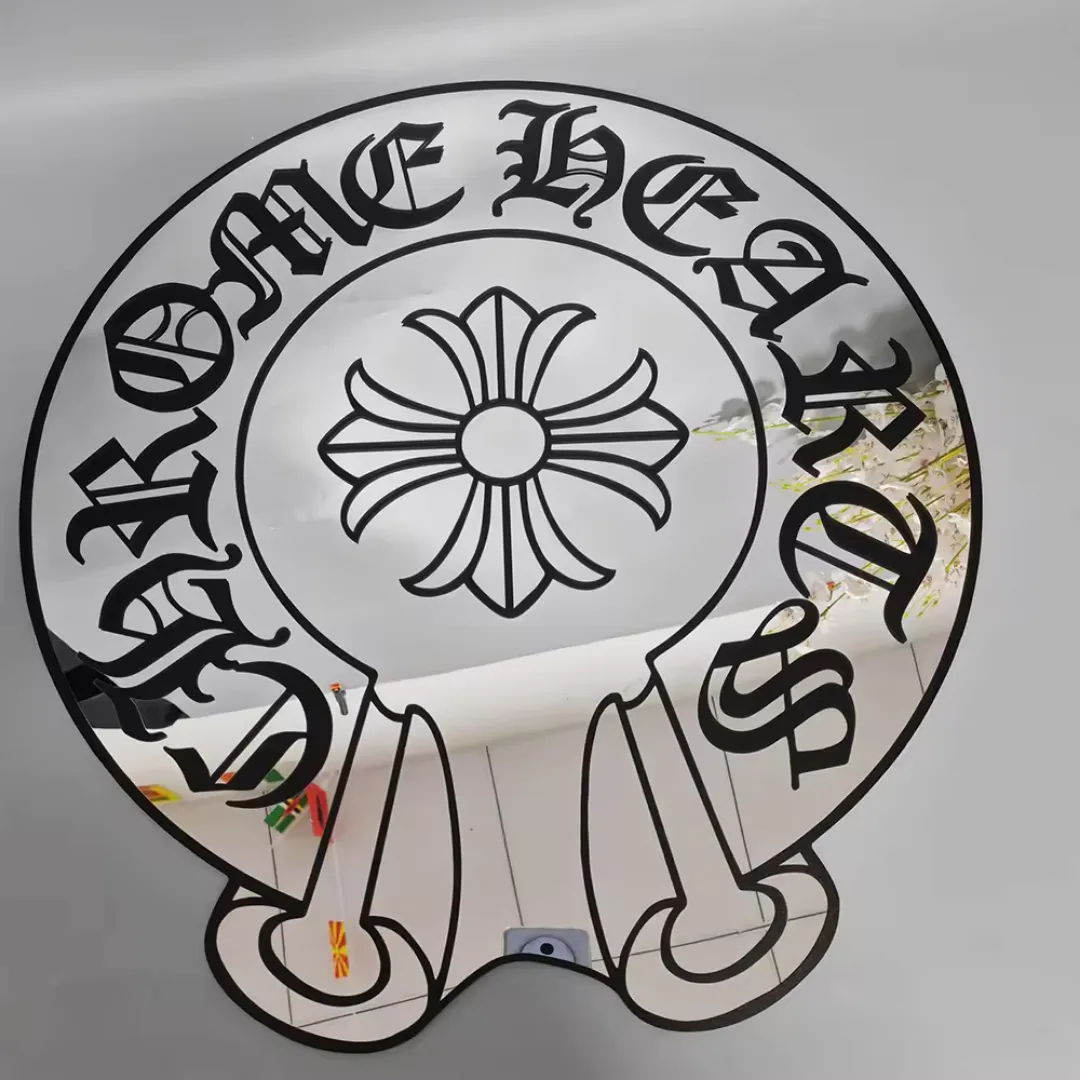 Gothic cross acrylic mirror with circular frame and black gothic typography clean product display