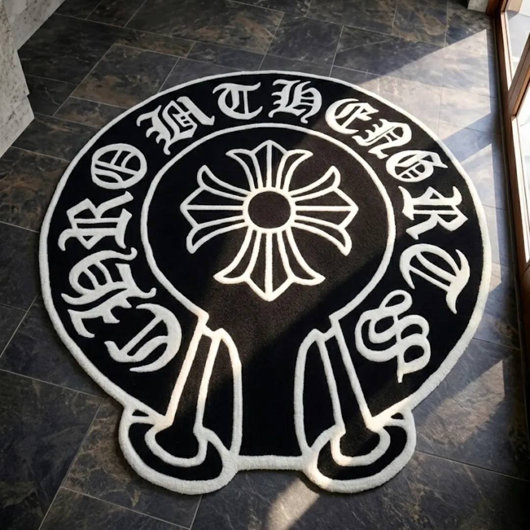 Perspective lifestyle view of the Midnight Noir Crest rug placed on a dark tile floor in a sunlit room, showcasing its circular shape with extended bottom details and the bold black and white streetwear-inspired design.