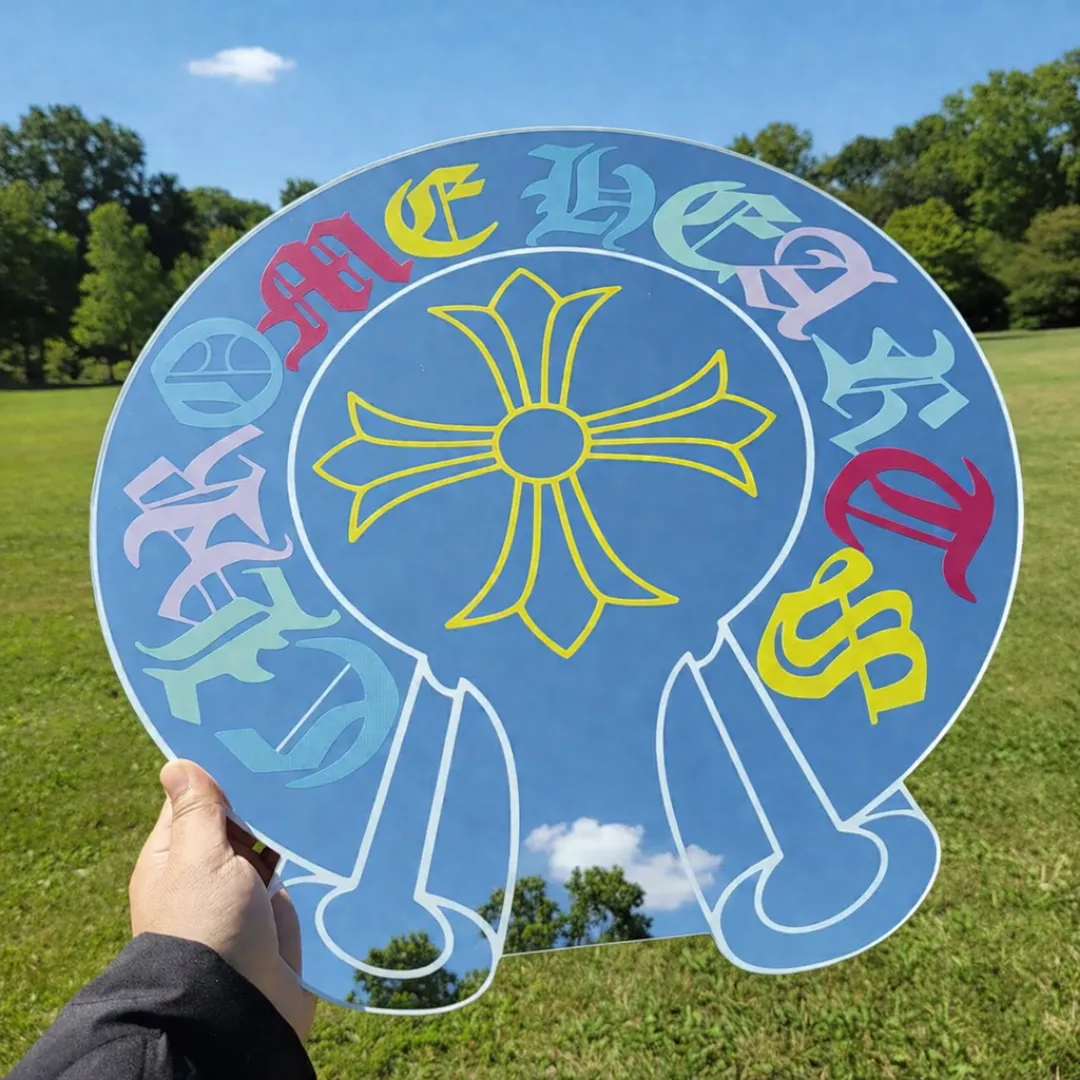 modern gothic cross acrylic mirror outdoor reflection Modern gothic cross acrylic mirror with colorful old English lettering held outdoors reflecting blue sky