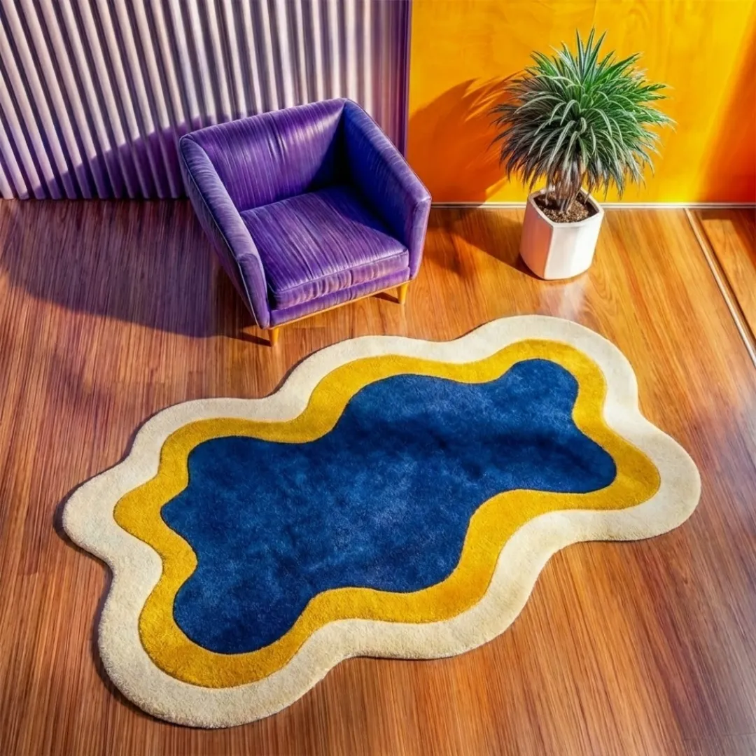 High-angle lifestyle view of the Noctail Glow rug showcasing its plush, hand-tufted wool texture and the elegant, curved design of its blue, yellow, and cream layers in a bright, sunlit interior.