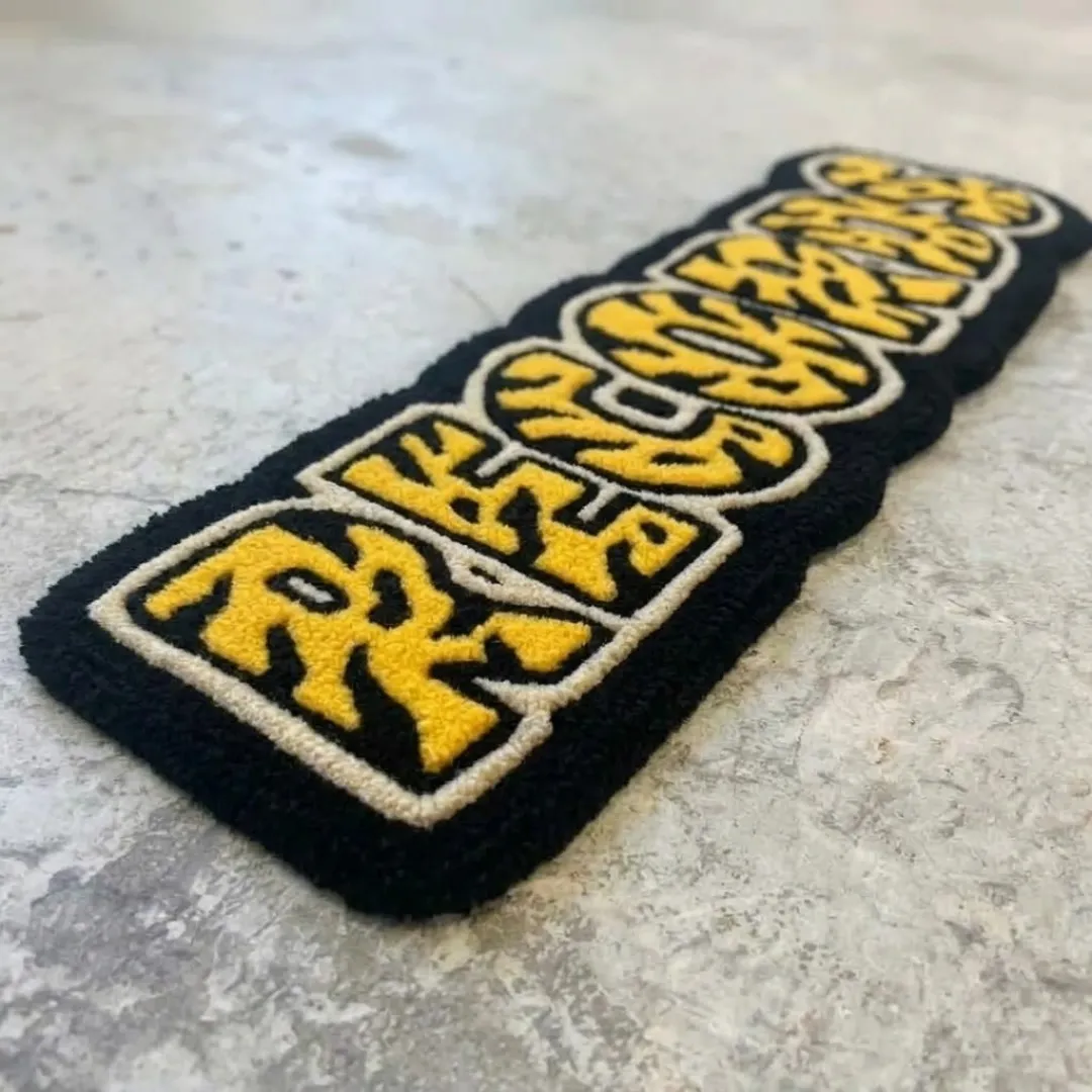 Low side-angle perspective shot showing the elongated shape and plush pile profile of the Record Rug.