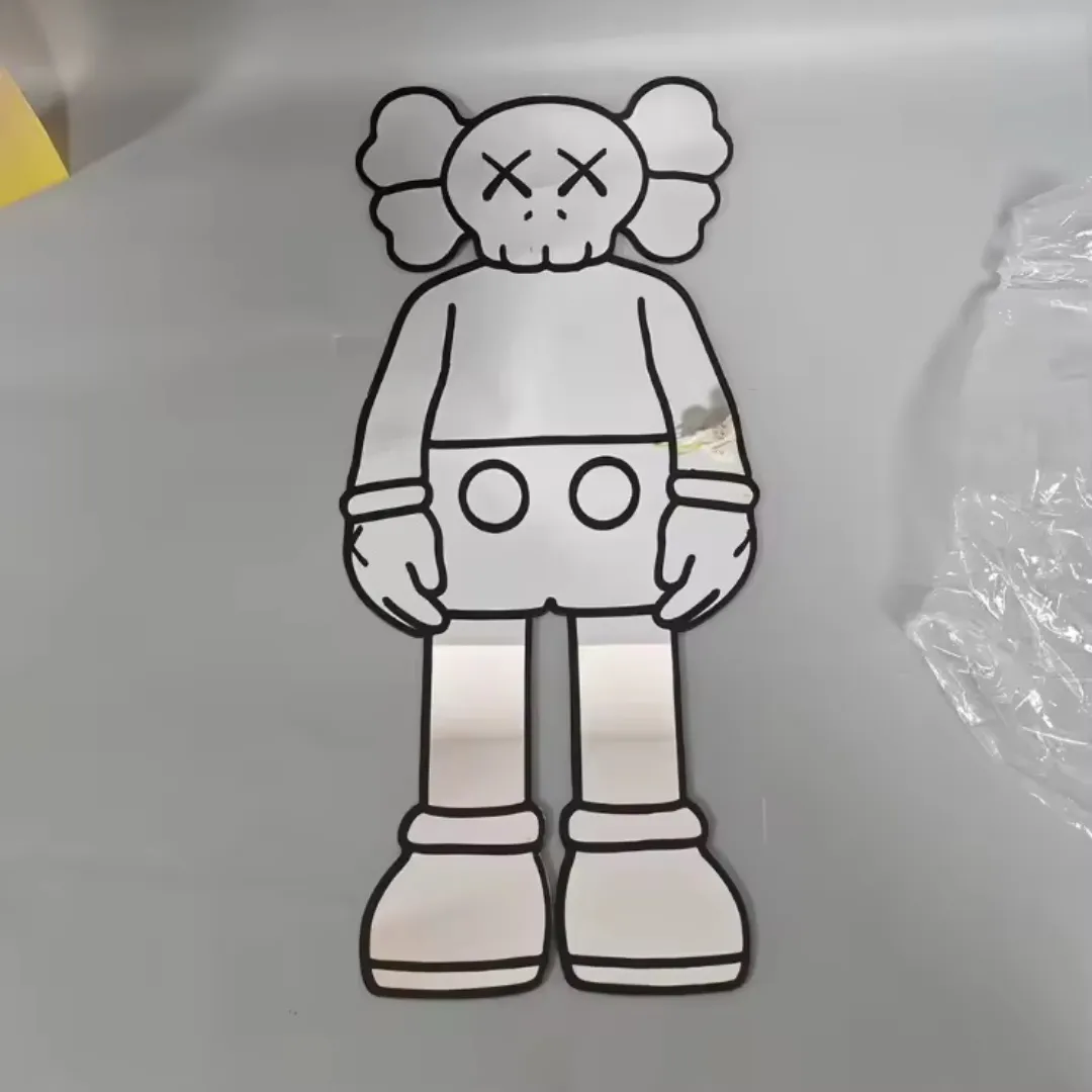 A full-body shaped mirror featuring a streetwear-inspired bear character with signature X-eyes, outlined in thick black lines and lying flat on a grey surface.