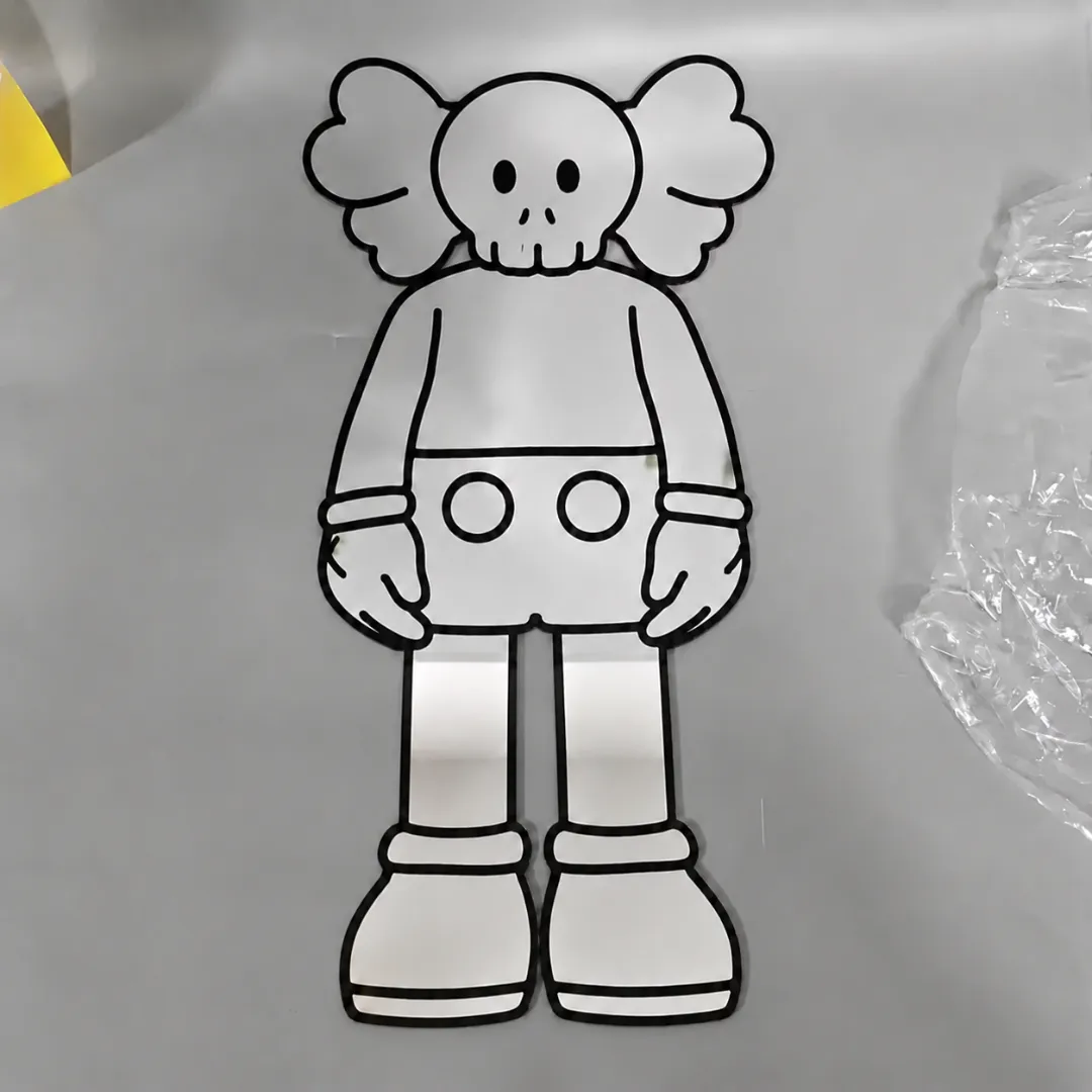 street bear character mirror flat pic A full-body shaped mirror featuring a streetwear-inspired bear character with signature X-eyes, outlined in thick black lines and lying flat on a grey surface.