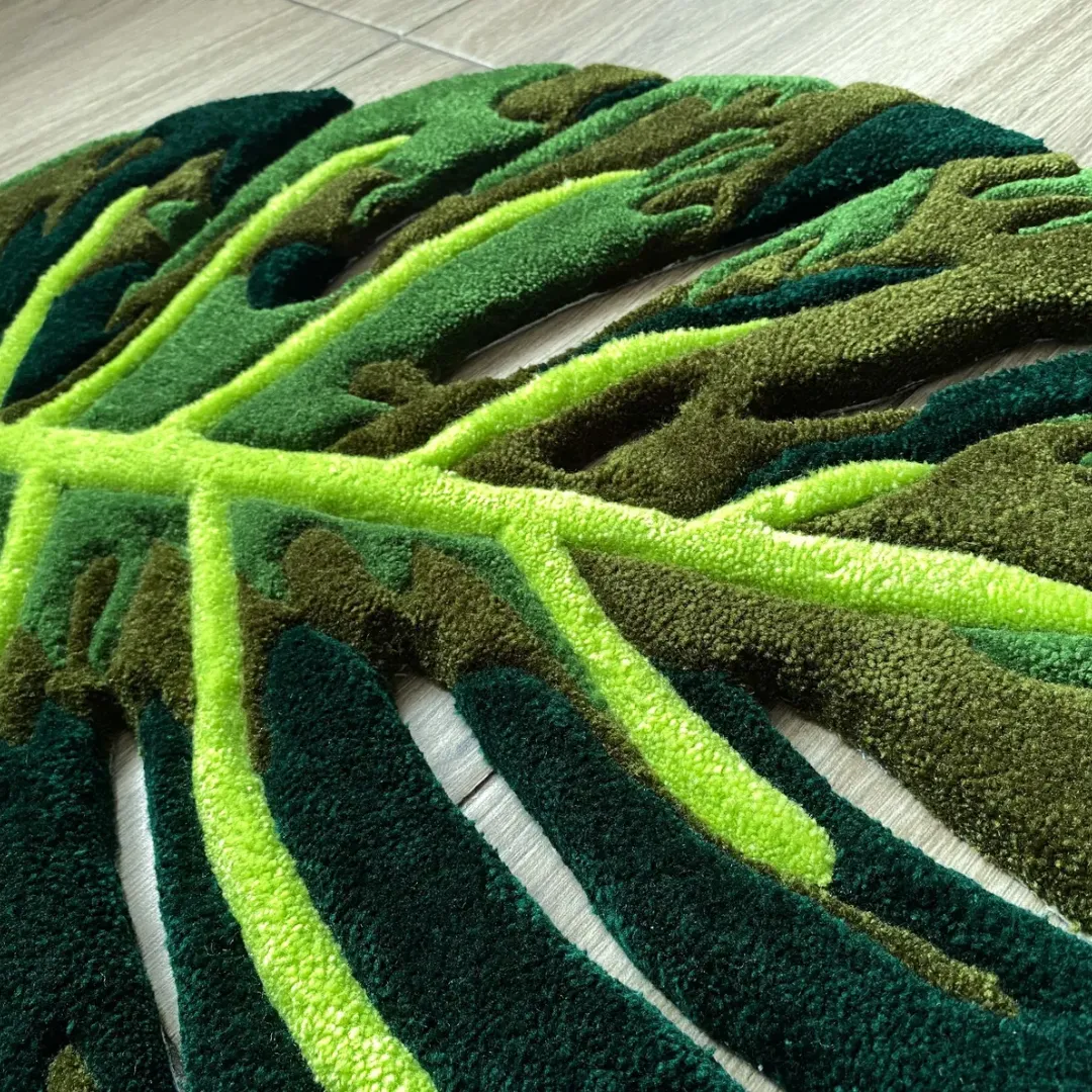 A close-up detail of the Monstera Flux Rug, highlighting the thick tufted yarn texture, bright lime green leaf veins, and deep green contrasting shadows.