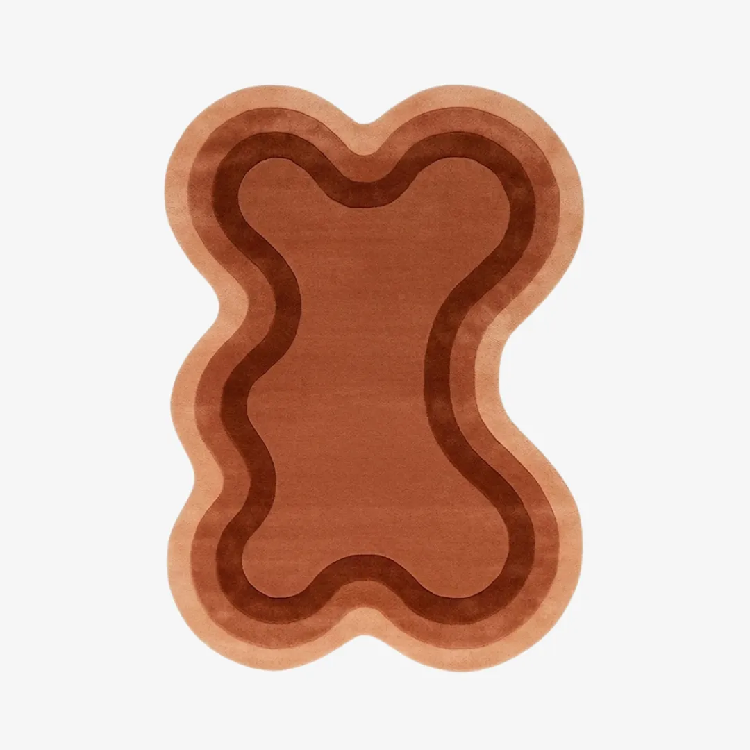 Arden Clay organic irregular-shaped tufted area rug featuring layered terracotta and warm brown wave gradient lines, displayed flat.