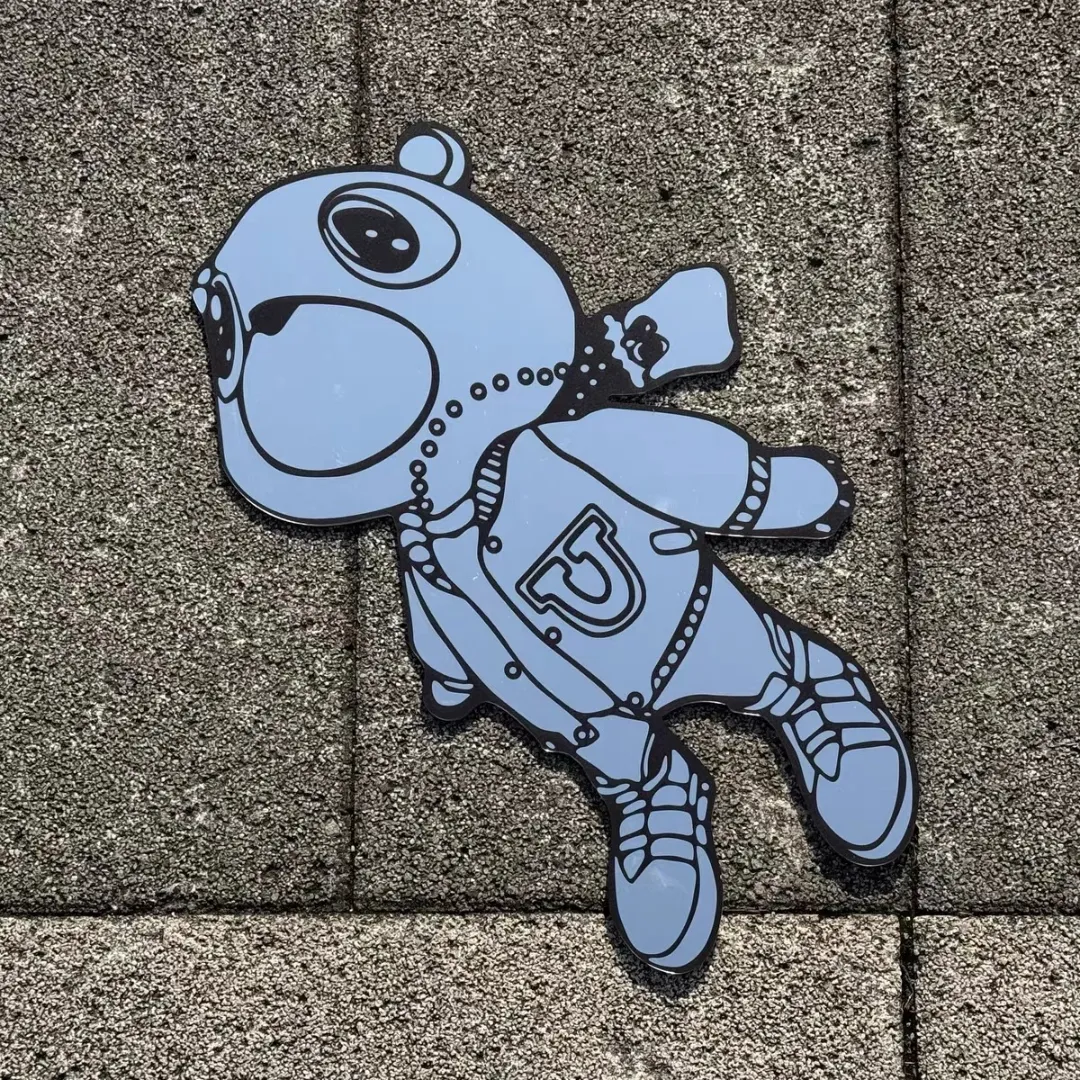 bear dropout full figure mirror stone view Bear Dropout full-figure cartoon bear wall mirror displayed flat on an outdoor stone tile surface.