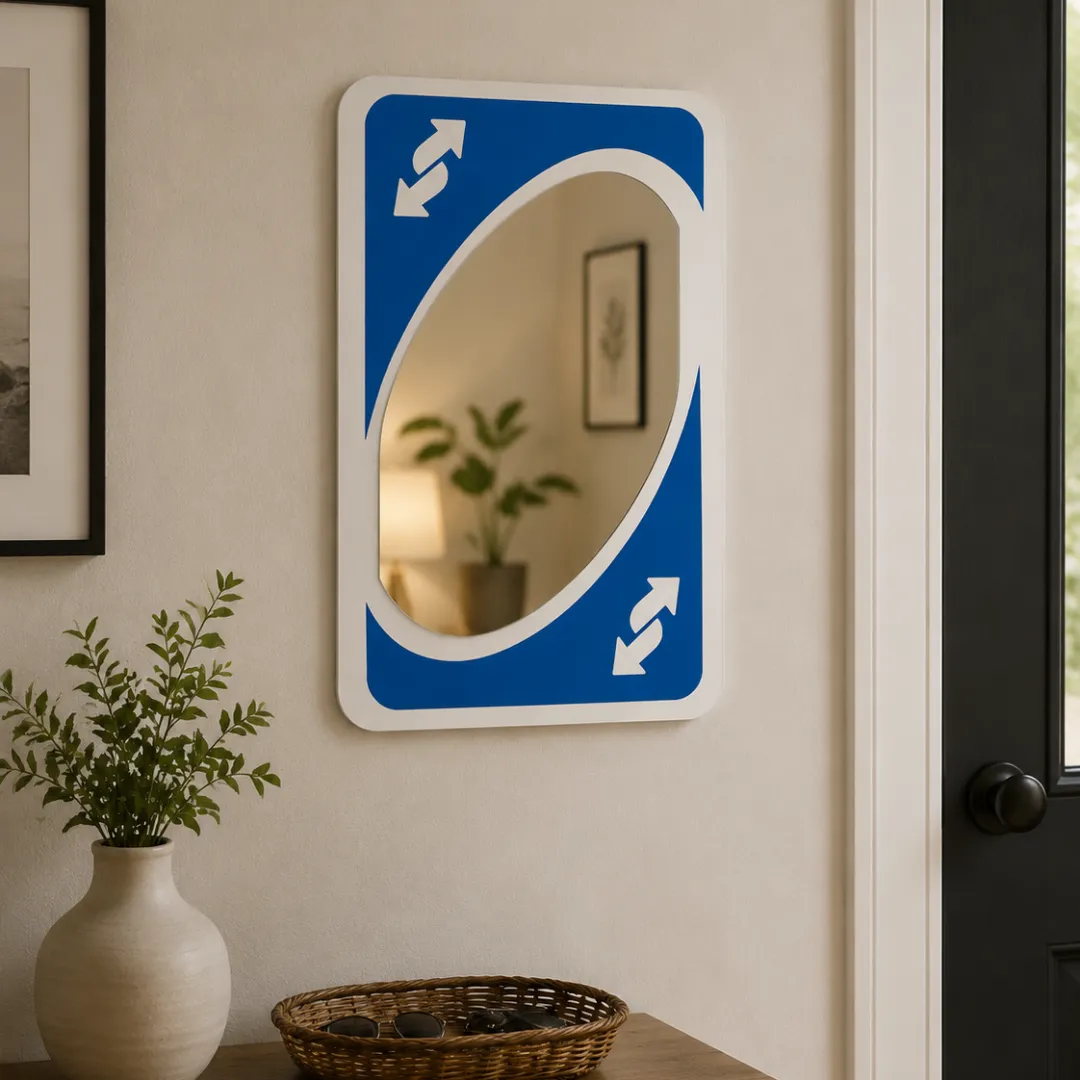 Blue Card Shift novelty Uno reverse card wall mirror styled in a modern entryway with a decorative bowl, plant, and wooden table.