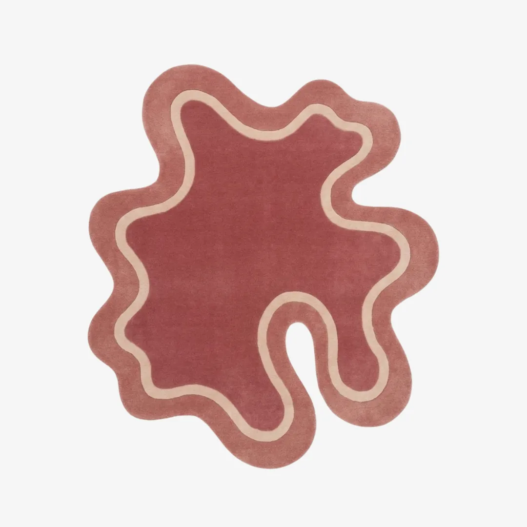 blush amoeba rug top view Blush Amoeba organic irregular-shaped tufted area rug featuring a playful pink tone and contrasting cream border lines, displayed flat.
