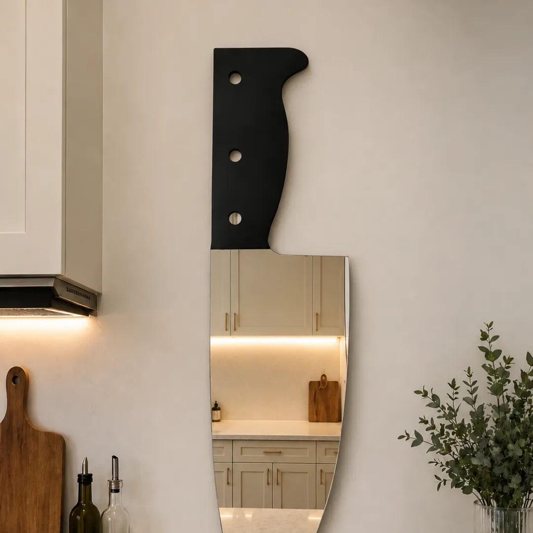 chef knife mirror kitchen mockup Chef Knife novelty kitchen knife wall mirror styled in a modern kitchen setting above a countertop next to cabinets and oil bottles.