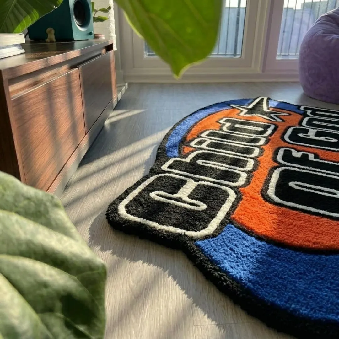 child of good rug low angle texture view Low-angle view of the Child Of Good tufted rug showcasing its plush wool texture, carved lettering contours, and rich primary colors.