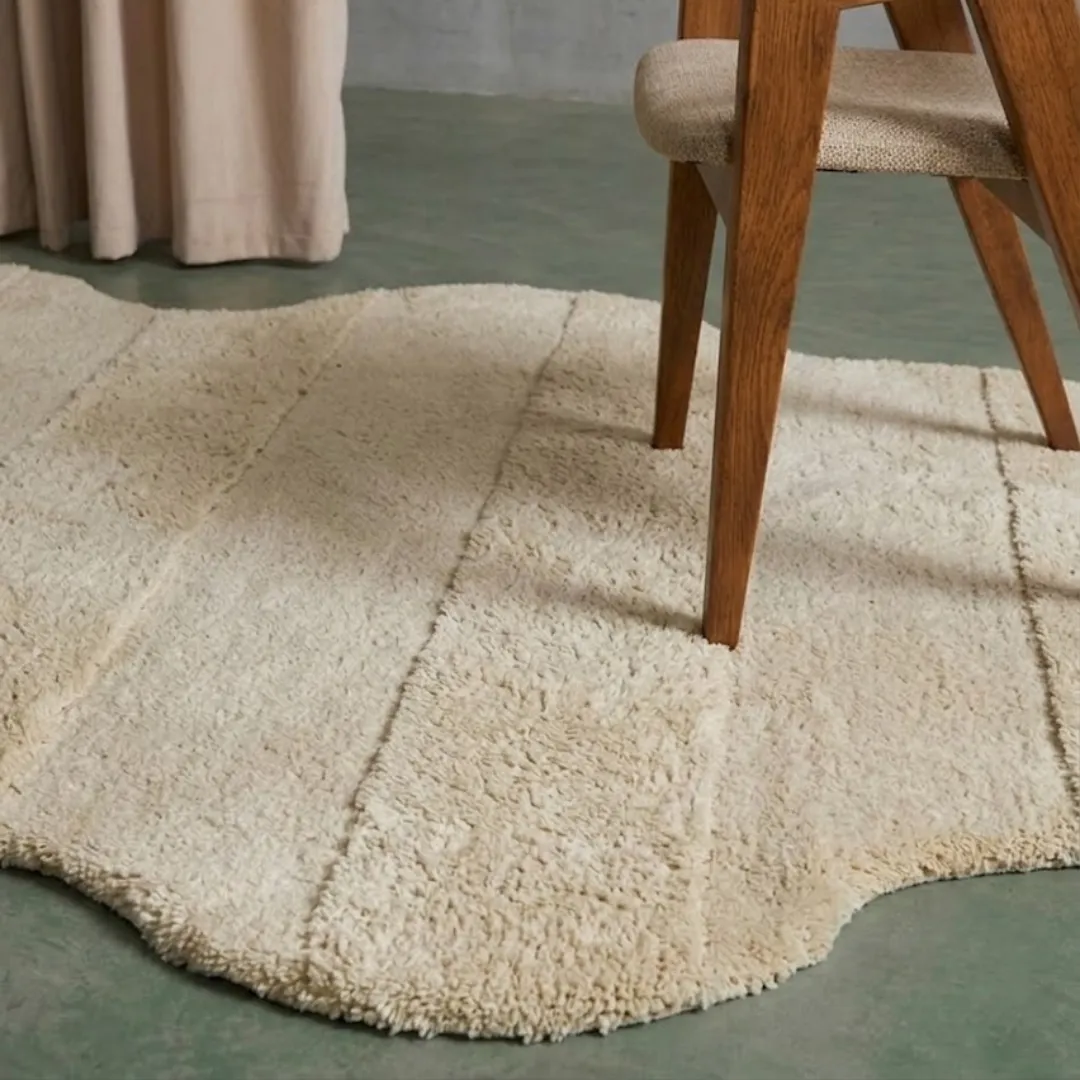 Close-up of the plush tufted pile texture, horizontal stripe detailing, and soft beige tones on the Cloud Ripple rug.