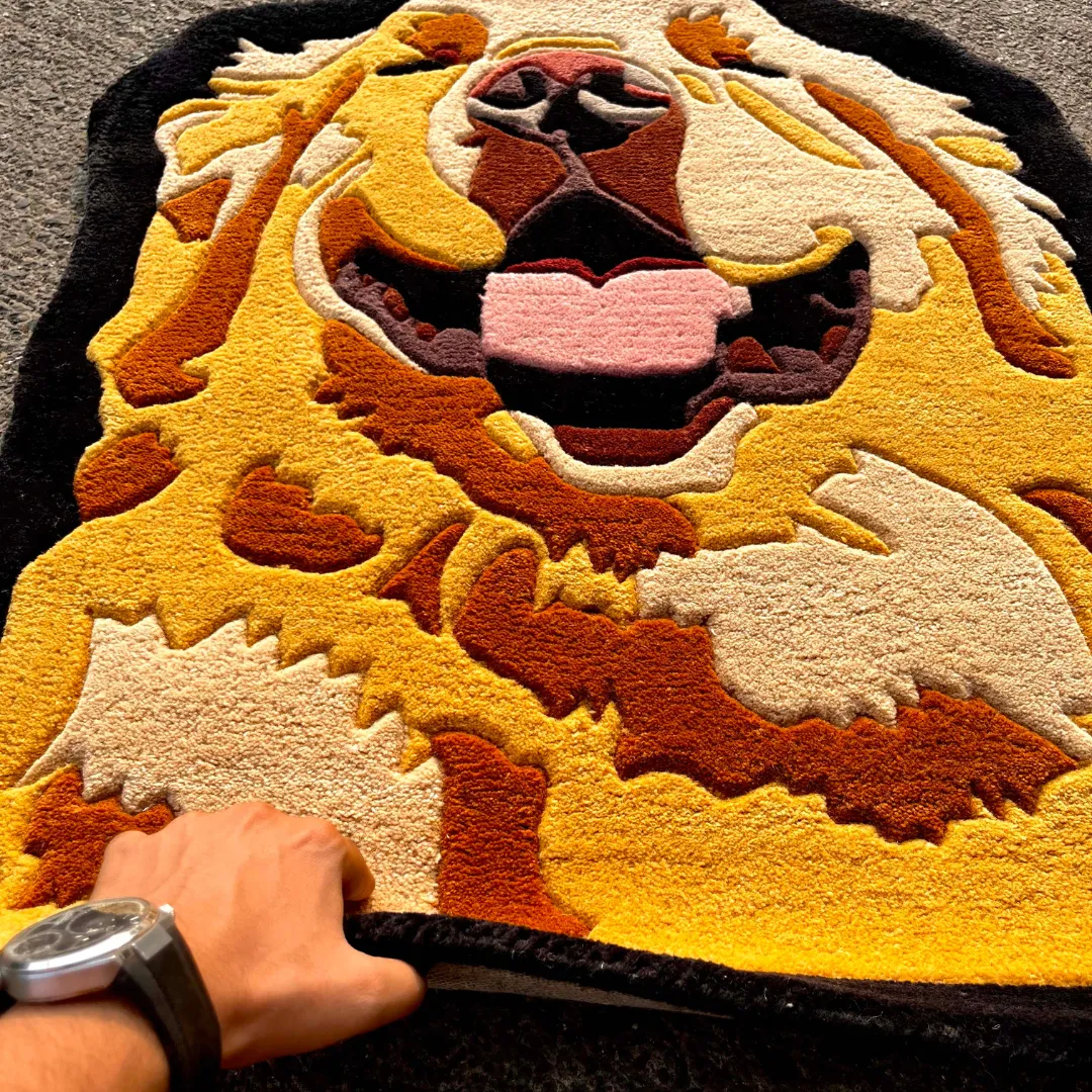 golden lion rug hand held view Hand-held angle view of the Golden Lion tufted rug showcasing its plush texture, carved details, and rich color blocking.