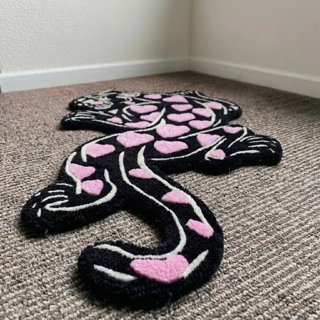 heart panther rug angle view Angle view of the Heart Panther tufted rug showcasing its custom panther silhouette, plush wool texture, and unique character shape.