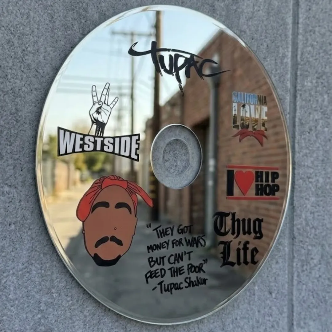 hip hop disc mirror park view Hip Hop Disc novelty CD-shaped mirror featuring iconic hip-hop graphics, reflecting an outdoor park with palm trees and greenery.