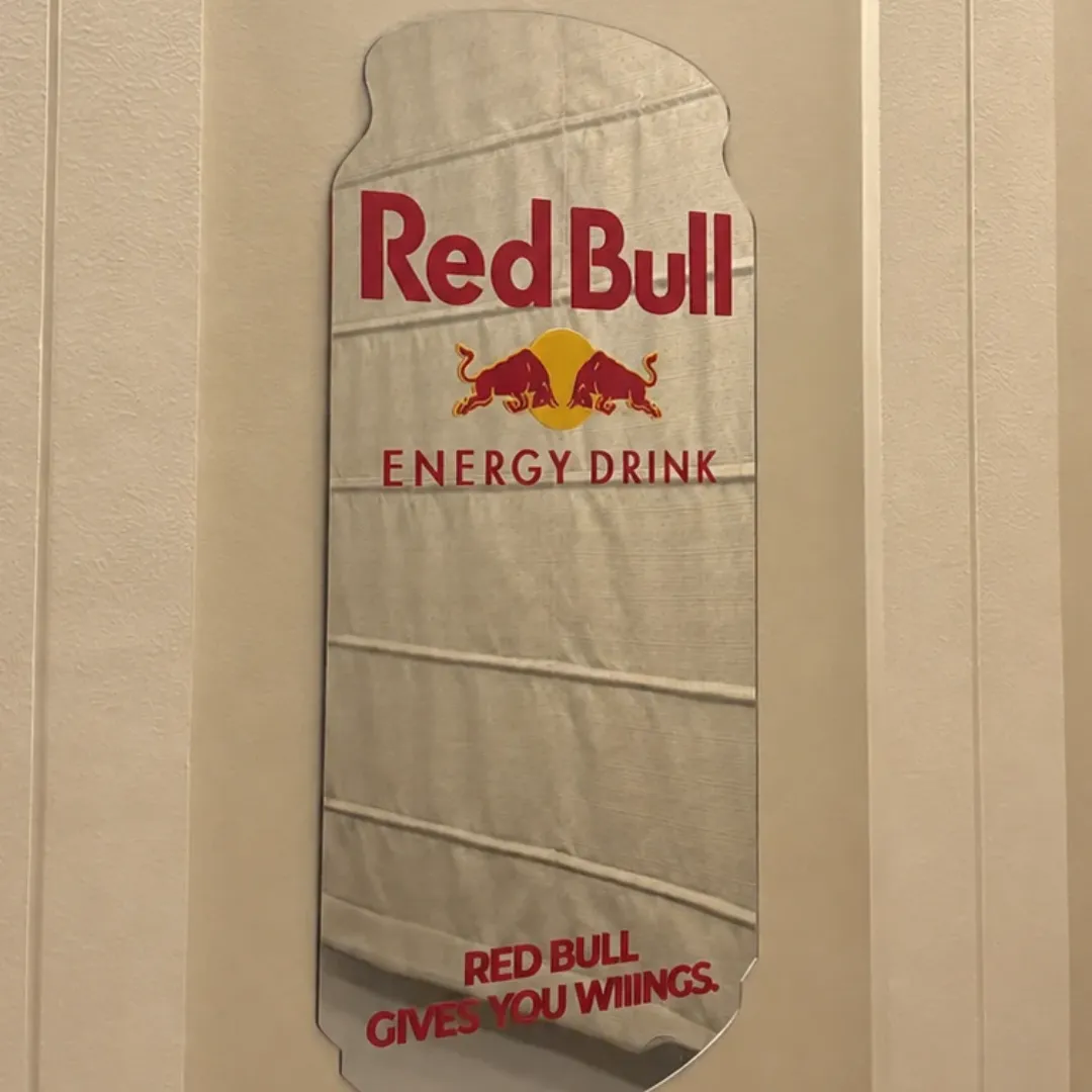 lunavex mirror wall view Lunavex designer Red Bull can mirror mounted vertically on a neutral wall reflecting light blinds.